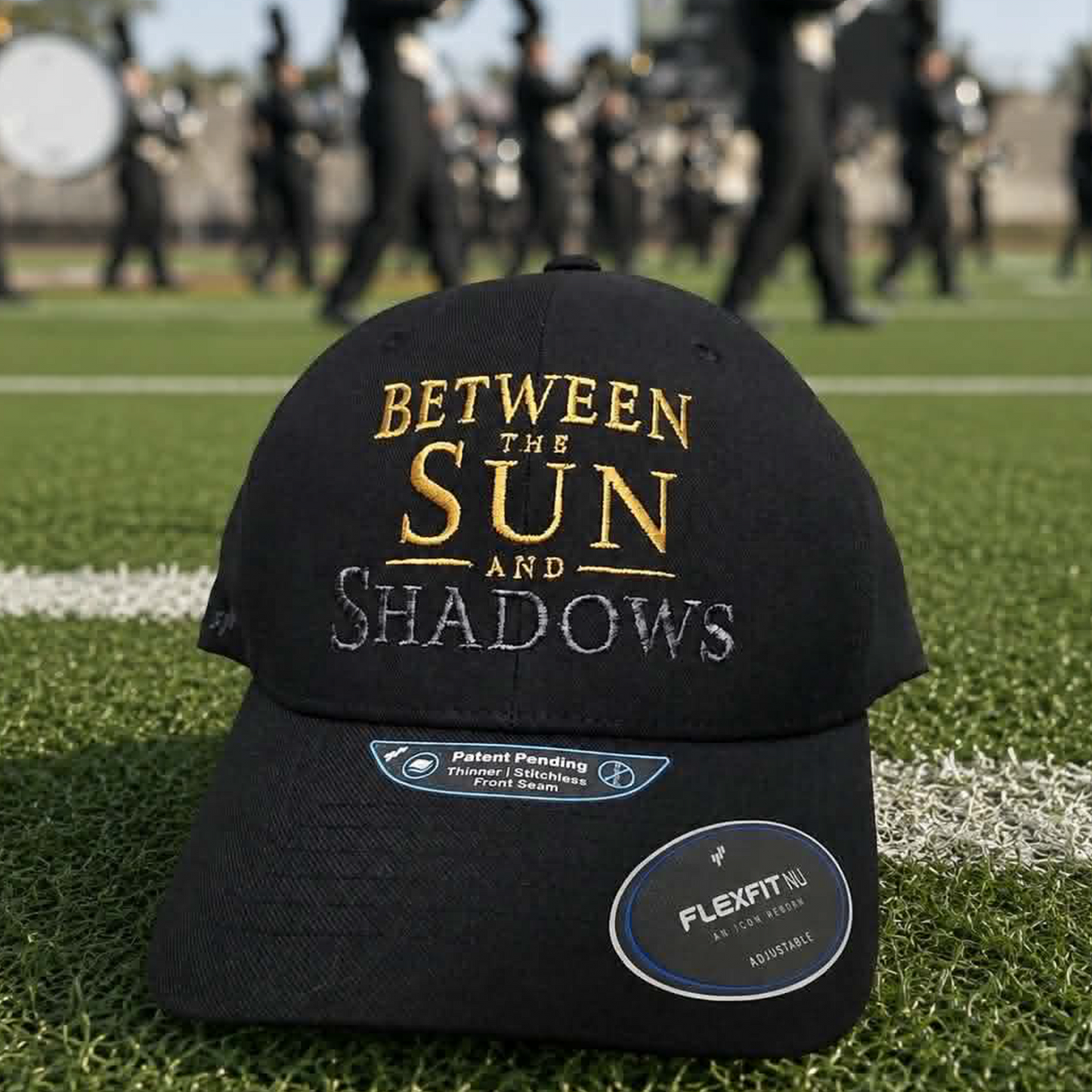 An angled view of the black baseball cap, showing the gold and silver embroidery and the side panels.